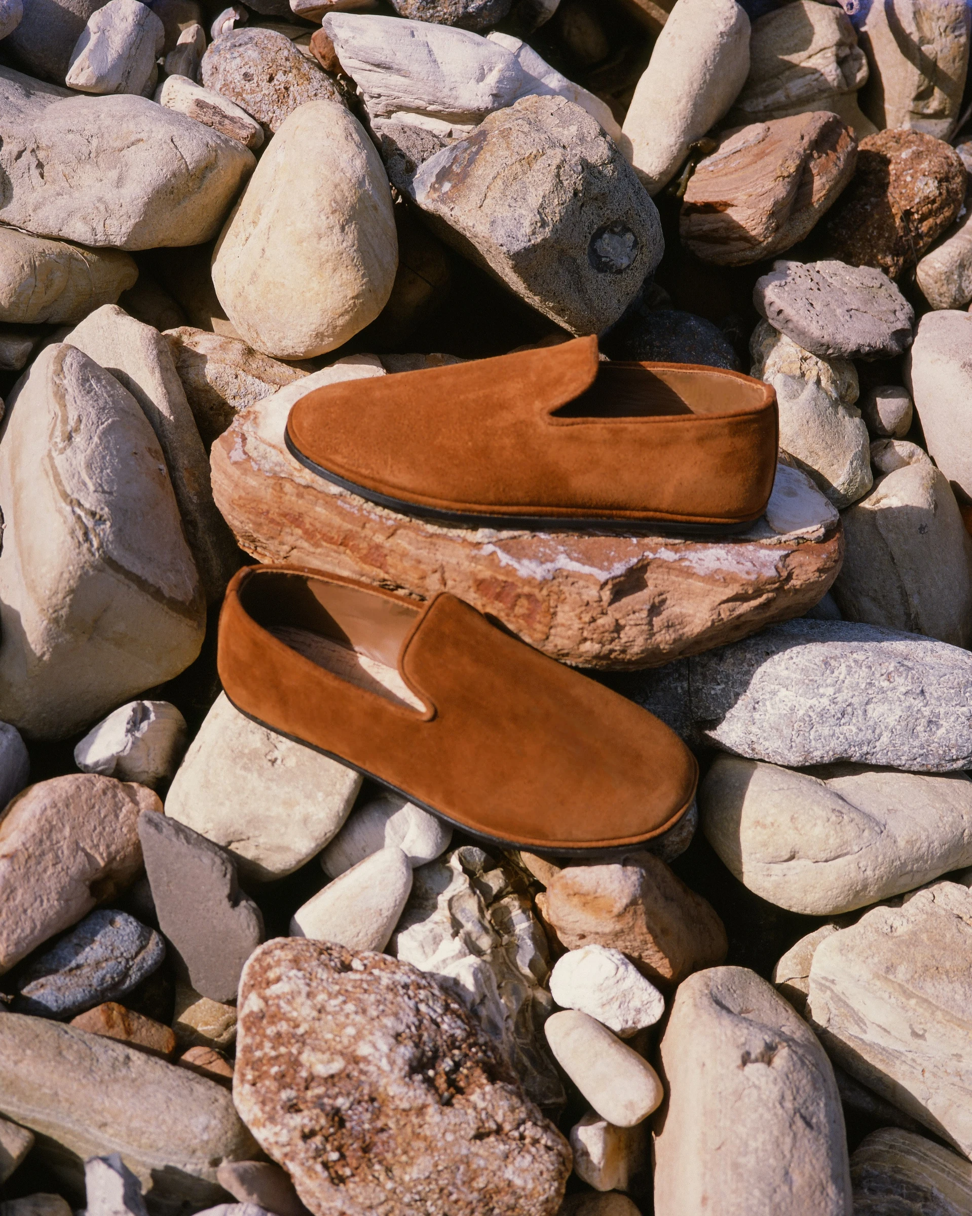 The Glen in Tobacco Suede on coastal rocks