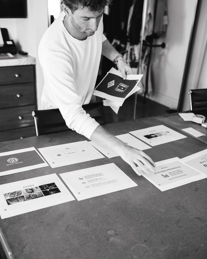 Devyn reviewing designs at a worktable