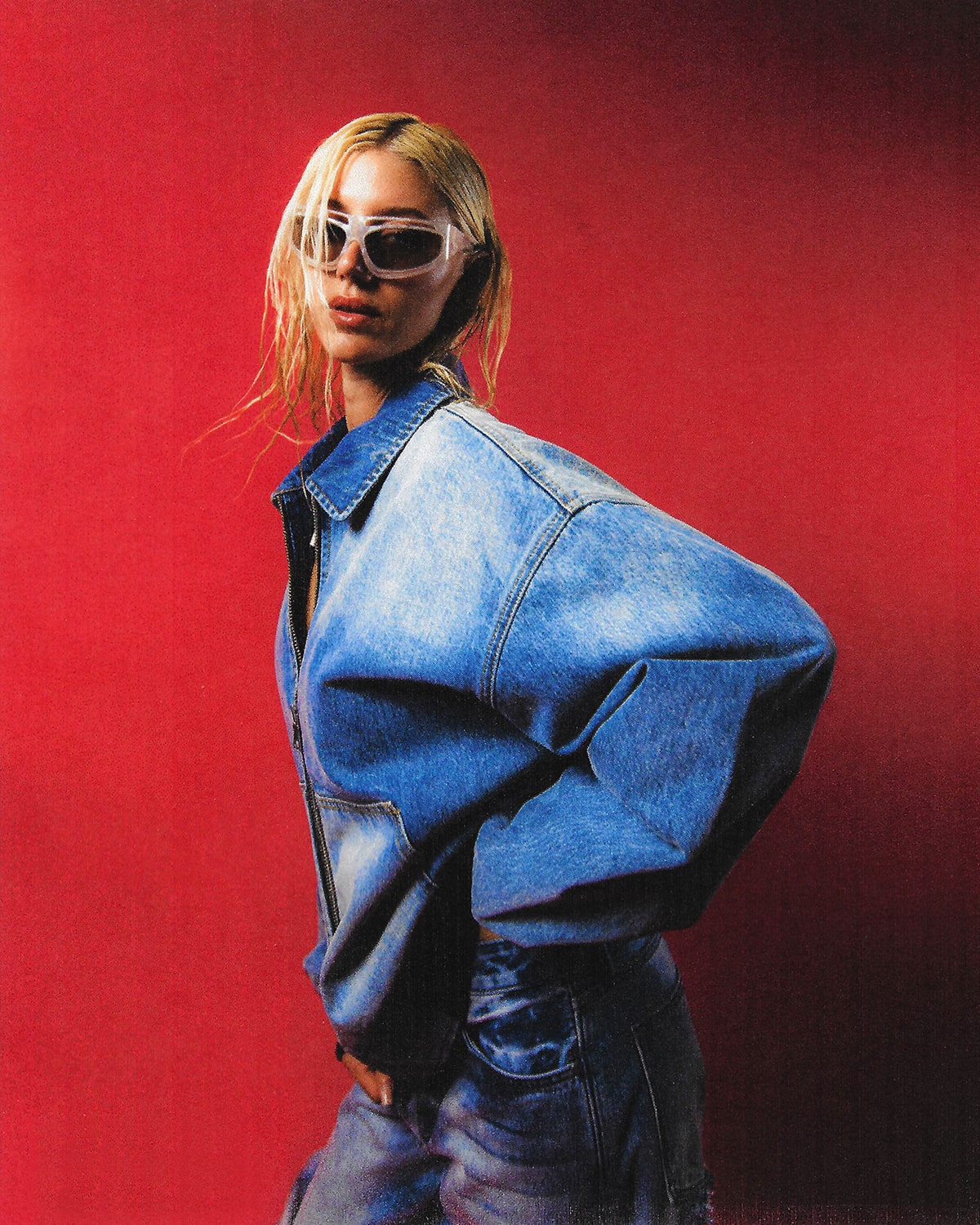 EVISU Capsule Zero campaign: blue denim against a red backdrop