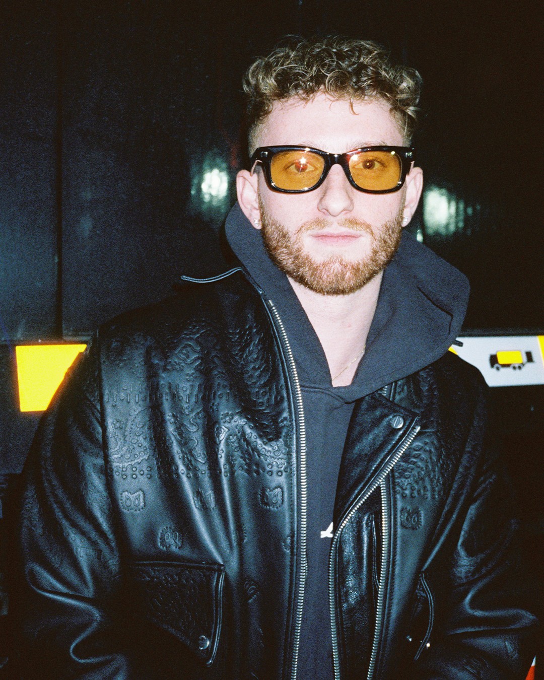 Devyn DiStasio in amber glasses and a leather jacket